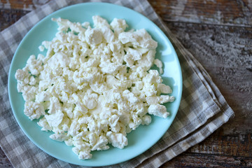 Selective focus. Fresh homemade cottage cheese on a plate.