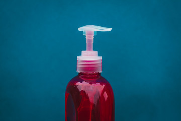 Pump bottle of red soap for cleaning and disinfecting hands