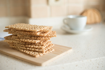 Wheat crispbreads on the kitchen table, selective focus.