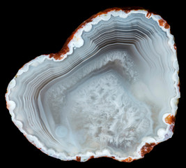 Slise of agate geode with quartz in the central part on black. Russia, Kemerovo region, deposit...