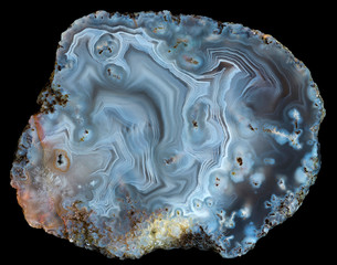 Slice of fancy pattern blue agate geode on black. Russia, Kemerovo region, deposit Yachmenuha