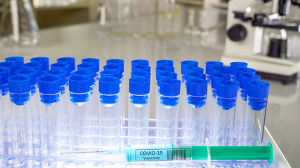 Test tubes with blue cap on it and the coronavirus vaccine