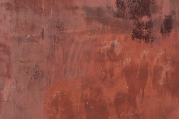 Red metal sheet covered with old, old paint