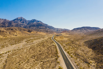 Aerial top view of the mountains and highway road in Death Valley national park, USA country