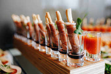 Beautifully decorated catering banquet table with different food snacks and appetizers with sandwich