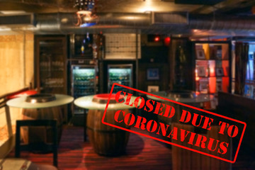 Defocused view of interior of an upmarket bar or pub, empty and closed due to coronavirus