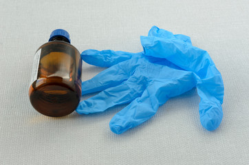 Blue medical gloves and alcohol, concept of protection against covid-19.