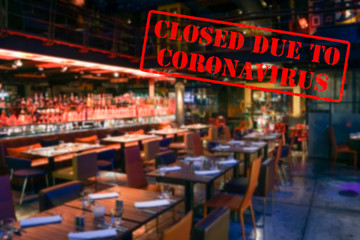 Defocused, blurred view of interior of an upmarket bar or restaurant, empty and closed due to coronavirus or covid 19 pandemics
