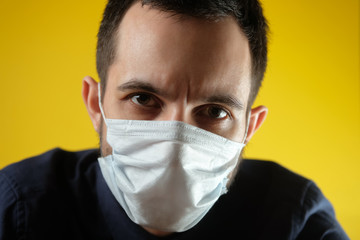 Man in a medical mask is upset about the coronavirus and the quarantine.