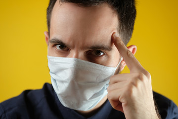 Man in a medical mask is upset about the coronavirus and the quarantine. Think of others, stay at home.