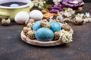 Process of painting Easter eggs in blue