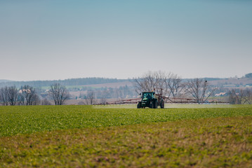 Fototapeta premium Agriculture Tractor Working in Field