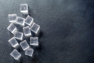 Fresh ice cubes and reflections on black background