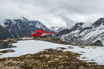 Helicopter landed in remote wilderness of Alaska's Talkeetna Mountain Range.