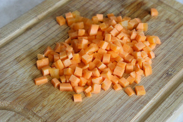 Carrots diced close-up on a wooden Board. Process of cooking.