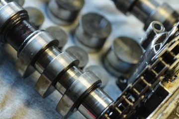 Camshaft and hydraulic compensators on the repair table. Close-up