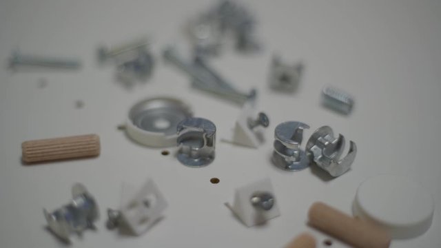 Close up men's hand puts details for furniture. Minifix Furniture