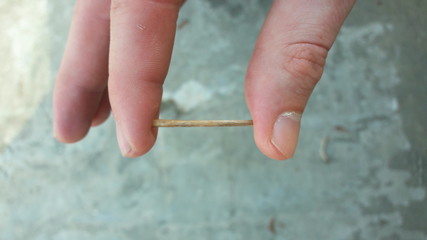 Fingers Holding A Stick