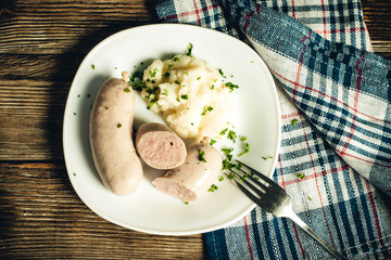sausages and mashed potatoes on a plate close-up