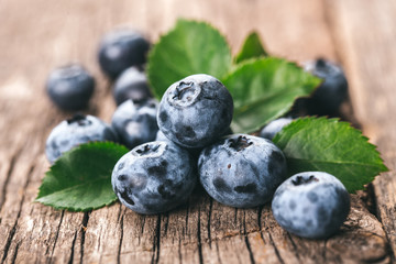 Freshly picked blueberries on wooden background. Healthy eating and nutrition.