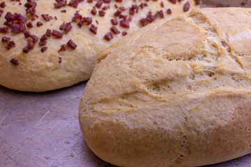 Fresh home baked breads, make out of wheat, one simple and one with pepperoni on top