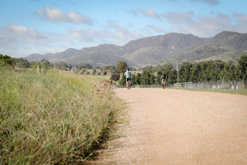 Obraz premium Two brothers riding bikes on country road during self isolation in Mudgee, New South Wales Australia