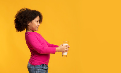 Adorable Little Black Girl Holding Glass With Milk And Offering It