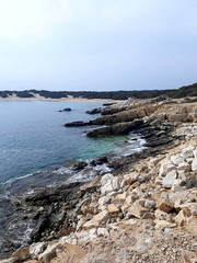 Beautiful stony coast in Naxos at sunset light