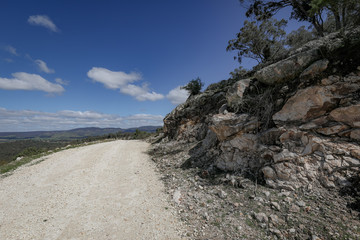 Gravel road leading to remote quarry along rocky cliff in central New South Wales
