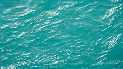 Pure turquoise smooth water surface aerial view