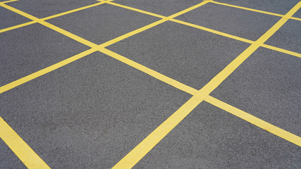  Asphalt in yellow diagonal stripes. road marking. dark gray asphalt in yellow rhombs.