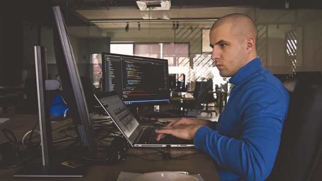 The programmer girl works at the computer