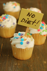 No diet sign on vanilla cupcakes with candies