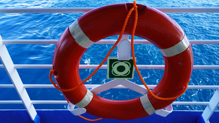 Ship safety equipment, red life buoy Observation deck on a cruise ship in clear weather against a...