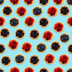 Seamless pattern, texture.Tasty tartlets with different berries,cranberries,bilberry,black currant . Berry tartlets. Cake with berries. Dessert with berries. Wooden background. Copy space.  