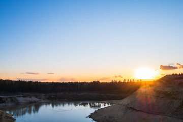 Sunset in the background of an abandoned quarry.