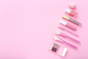 Makeup products on pink background. Top view