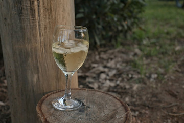 Glass of white wine on country property at sunset