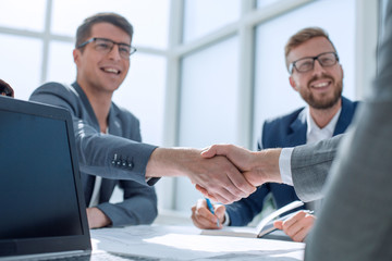 close up. business people shaking hands at a meeting in the office