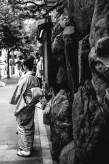 Woman with kimono at Kyoto downtown street, Japan	 (in black and white)