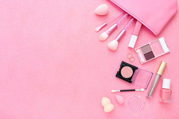 Obraz na płótnie Canvas Set of professional decorative cosmetics, makeup tools and accessories on pink sparkle background. Beauty, fashion and concept. Flat lay composition, top view
