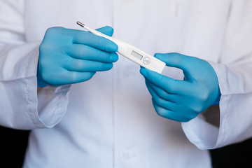 Male Doctor Wearing Gloves Showing Thermometer. Doctor with Thermometer in Hands. Thermometer Close Up. Healthy Life, Doctor, Virus Concept