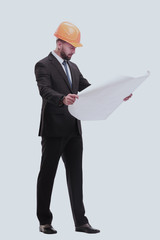 businessman in helmet looking at new drawings . isolated on white