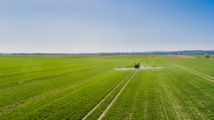 Tractor Spraying Herbicides on Field Agriculture