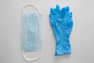 Medical gloves and a surgical face mask on a white background.Concept pandemic Covid-19, coronavirus protection