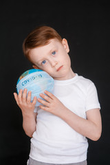 Kid in Self isolation looking at globe learning about Covid-19 Coronavirus from home, Child with...