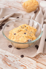 Bowl with sweet dough on table