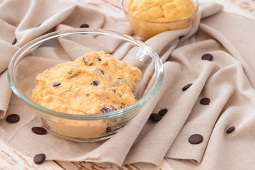 Bowl with sweet dough on table