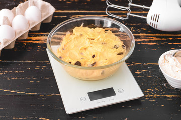 Preparing of sweet dough on table