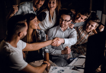 Fototapeta premium handshake of business people in the circle of colleagues